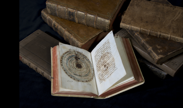 Astronomical manuscript open to a page showing a paper instrument. 