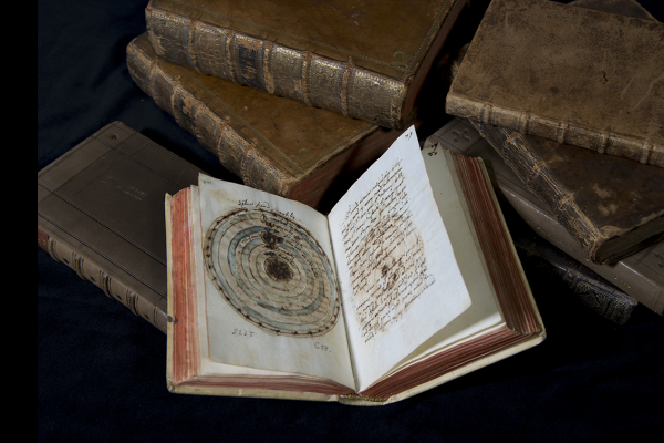 Astronomical manuscript open to a page showing a paper instrument. 