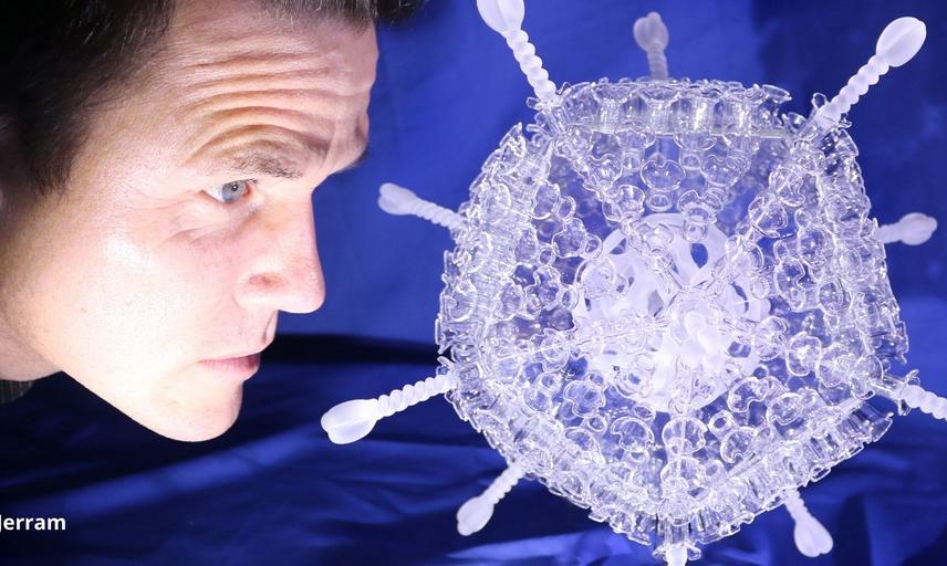 Luke Jerram with his COVID-19 vaccine glass sculpture