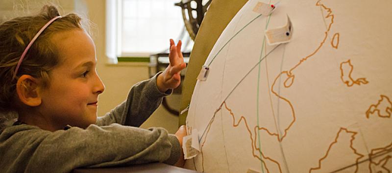 Globe Maker: photo of a child exploring one of the globes made for the project