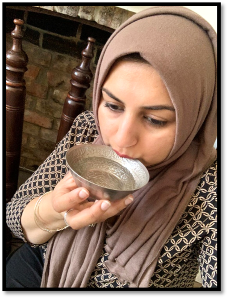 Multaka Volunteer Marriam drinking from her Healing Bowl, a gift from her father