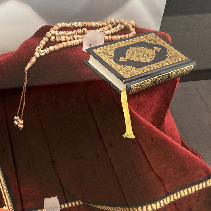 Prayer display: prayer beads, qu'ran and prayer mat
