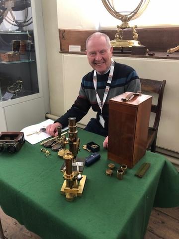 Harry Knight, Museum volunteer, with Greenbaum microscopes, preparing for object handling with Museum visitors
