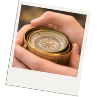 Hands holding compass for object handling