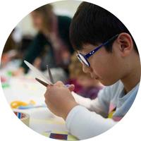 Young boy working at a craft activity at a family event