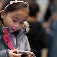 Young girl at family event looking at camera